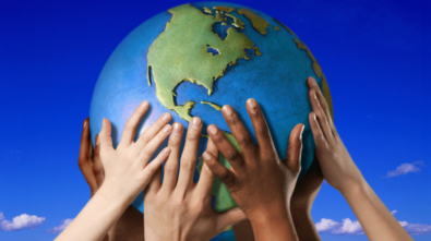 Hands on a globe --- Image by © Royalty-Free/Corbis